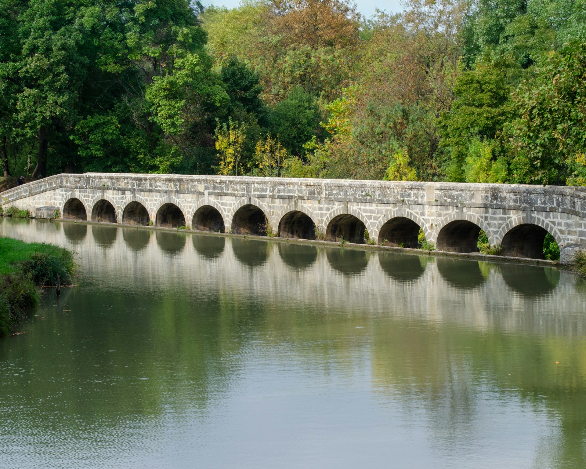 a stone bridge over a body of water
